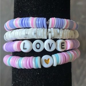 Bracelet set of four purple and pink themed.